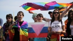 People take part in a gay pride rally in St. Petersburg in 2017. Activists say that the new law, which puts LGBT activism on par with inciting violence or distributing pornography, is being used to distract Russians from the war in Ukraine.