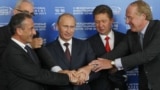 The signing of an agreement on the construction of the South Stream gas pipeline in Sochi in 2011. Rear left is Wintershall representative Harold Schwager. Russia was represented at the ceremony by then-Prime Minister Vladimir Putin (center) and Gazprom chief Aleksei Miller (second from right).