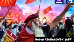 Macedonian protesters wave flags in front of the parliament building in Skopje during a demonstration earlier this year against a proposed change in the name of the country. Some analysts fear a "fake news" campaign could affect the outcome of an upcoming referendum on the issue. 