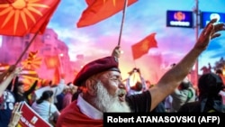 Demonstrators wave flags in front of the parliament building in Skopje during a protest earlier this year against a proposal to change the country's name to North Macedonia.