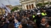 Supporters of the Revival party scuffle with police during an anti-government protest in front of the parliament in Sofia in May 2020.