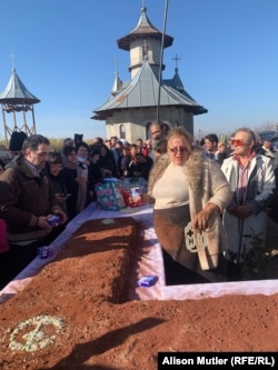 Sosoaca helps prepare a traditional funeral cake at the Plaviceni Monastery.