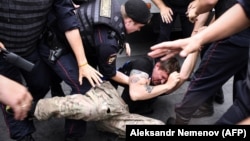 Russian police officers in Moscow detain a demonstrator during a march to protest against the alleged impunity of police officers in June 2019. (file photo)