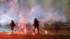 A firework explodes amid clashes between police and opposition protesters in the Georgian capital, Tbilisi.&nbsp;