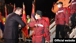 Serbian President Aleksandar Vucic (without mask) welcomes Chinese health experts and a planeload of medical supplies to Belgrade on March 21.