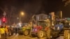 Students and others, some on tractors, block a bridge in Novi Sad, Serbia, on February 1.