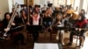 Music students practice their instruments at the Afghan National Institute of Music in Kabul before the Taliban takeover. Hundreds of musicians have fled the country since the militants, who deem music "un-Islamic," returned to power.