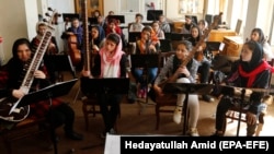 Music students practice their instruments at the Afghan National Institute of Music in Kabul before the Taliban takeover. Hundreds of musicians have fled the country since the militants, who deem music "un-Islamic," returned to power.