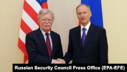 U.S. national-security adviser John Bolton (left) shakes hands with Russian Security Council Secretary Nikolai Patrushev during a meeting in Moscow on October 22. 