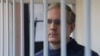 Paul Whelan, a former U.S. marine who was convicted for allegedly spying in Russia, stands inside a defendants' cage while attending a court hearing in Moscow. (file photo)