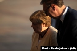 German Chancellor Angela Merkel is accompanied by Serbian President Aleksandar Vucic during her visit to Belgrade on September 13.