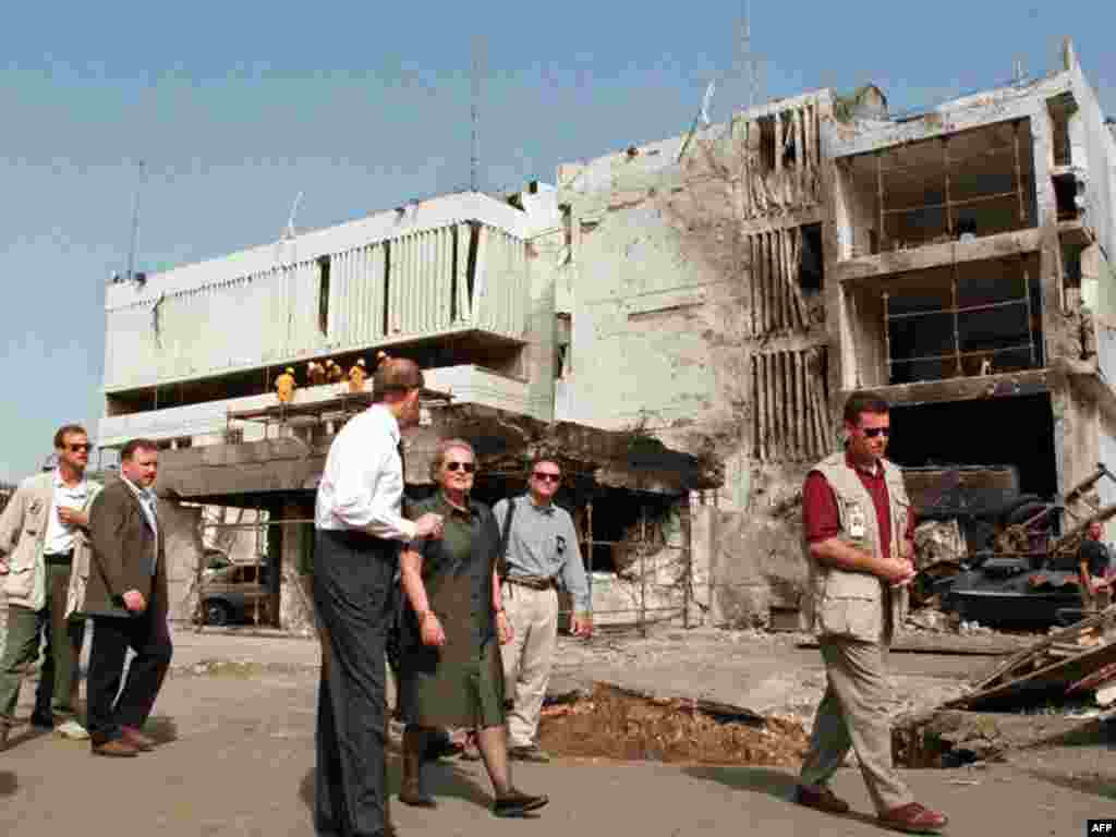 U.S. Secretary of State Madeleine Albright (center) walks past the damaged U.S. Embassy in Dar es Salaam, Tanzania, on August 1998, after a bomb attack credited to Al-Qaeda. At least 11 people were killed.