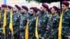 Hezbollah fighters take part in a funeral procession on September 25.