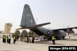 Packages of food and medical supplies donated by Pakistan to Afghanistan are unloaded at an airport in Kandahar in September.