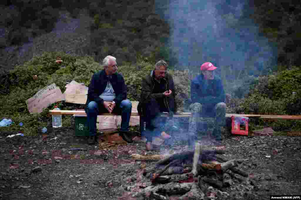 Kosovar Serbs sit by a bonfire near the border crossing at Jarinje on September 28.