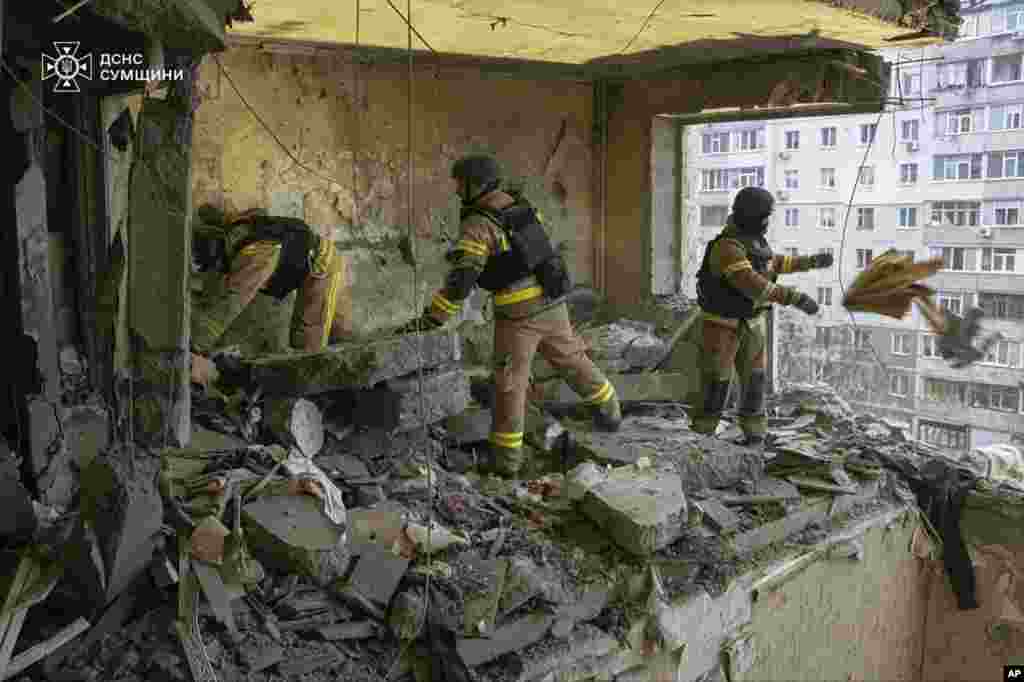 Rescuers search for civilians who were killed when a Russian drone hit an apartment building in Sumy, Ukraine.