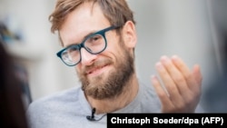 Activist Pyotr Verzilov smiles during an interview in Berlin on September 27, following his discharge from the hospital.