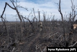 A file photo of a Ukrainian soldier moving through landscape near Klishchiyivka in March 2024.