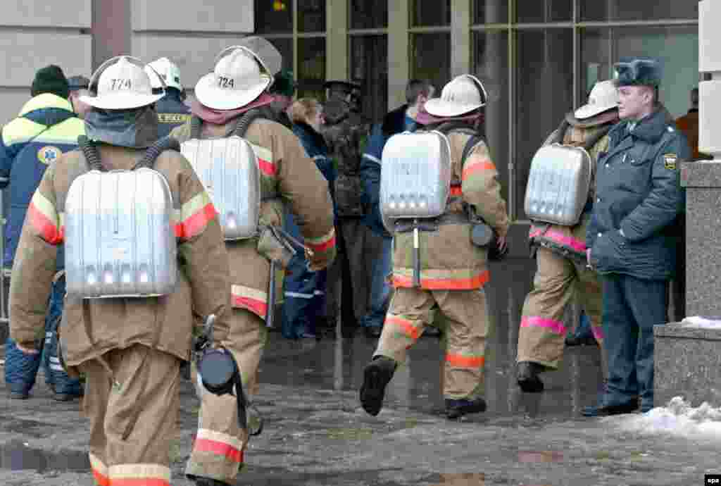 Firefighters enter the Paveletskaya metro station.