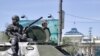 An armored vehicle patrols in front of the parliament building in Ulan Bator