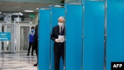 Kazakh President Qasym-Zhomart Toqaev votes during Kazakhstan's parliamentary election in Almaty on January 10, 2021.